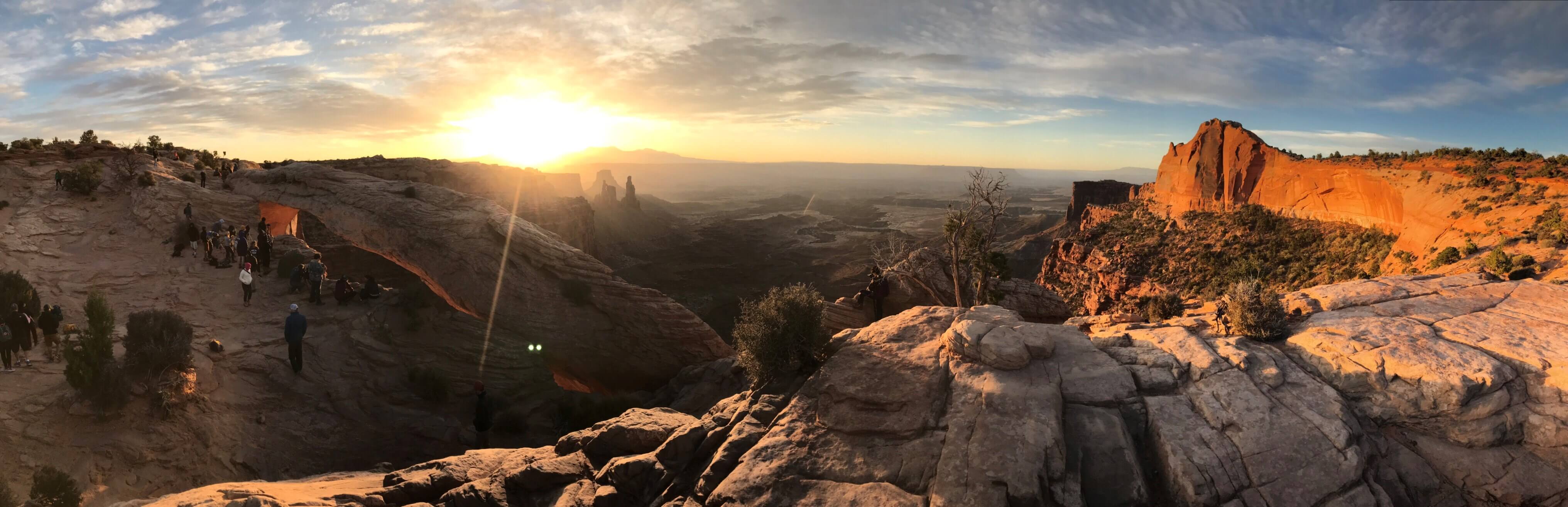 Enjoying the sunrise above Mesa Arch